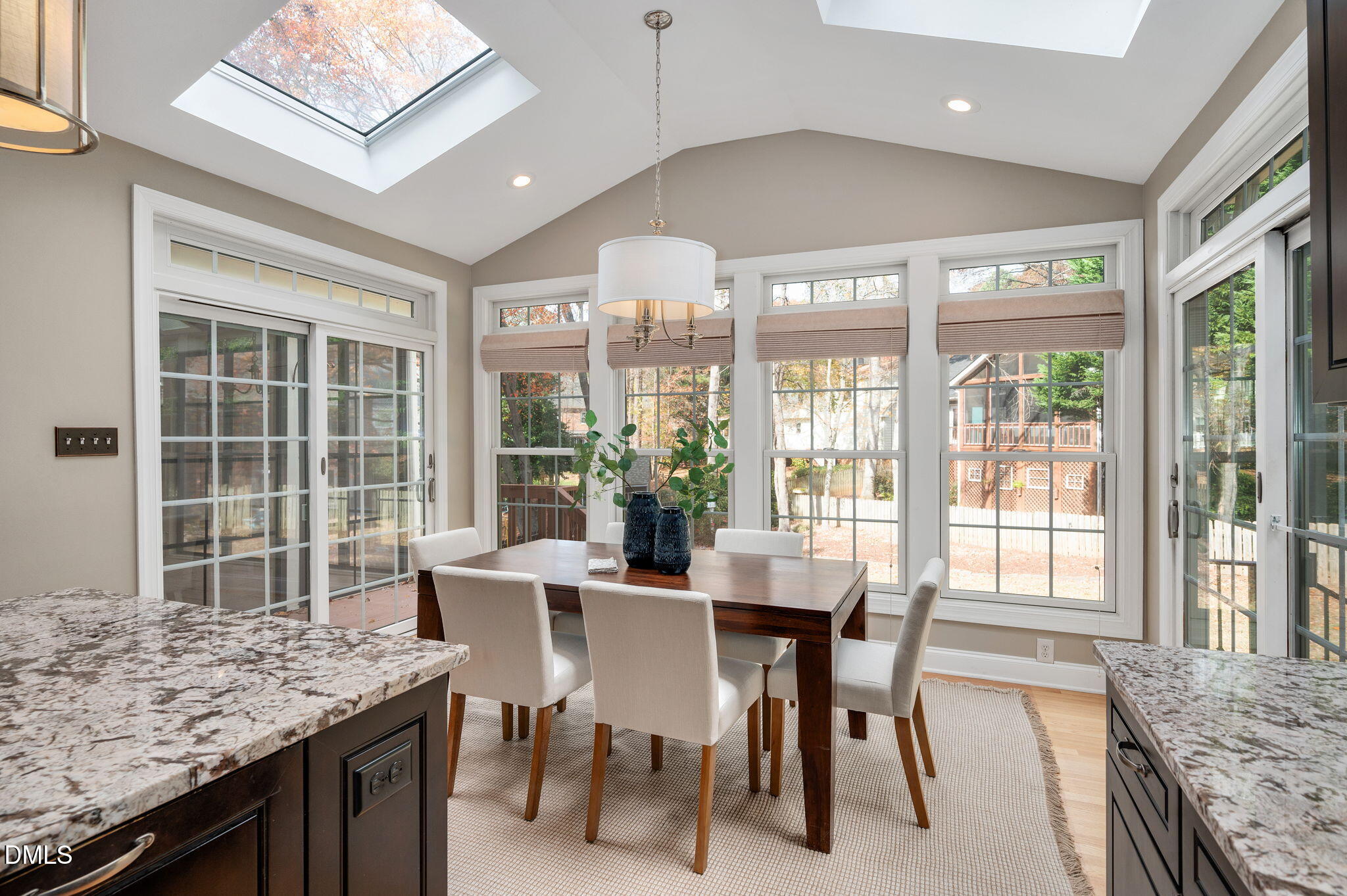 8325 Stryker Court Raleigh, NC 27615 - Photo 14 of 53 a view of a dining room with furniture large windows and wooden floor