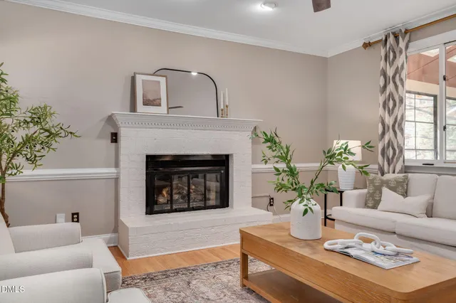 a living room with furniture and view of kitchen