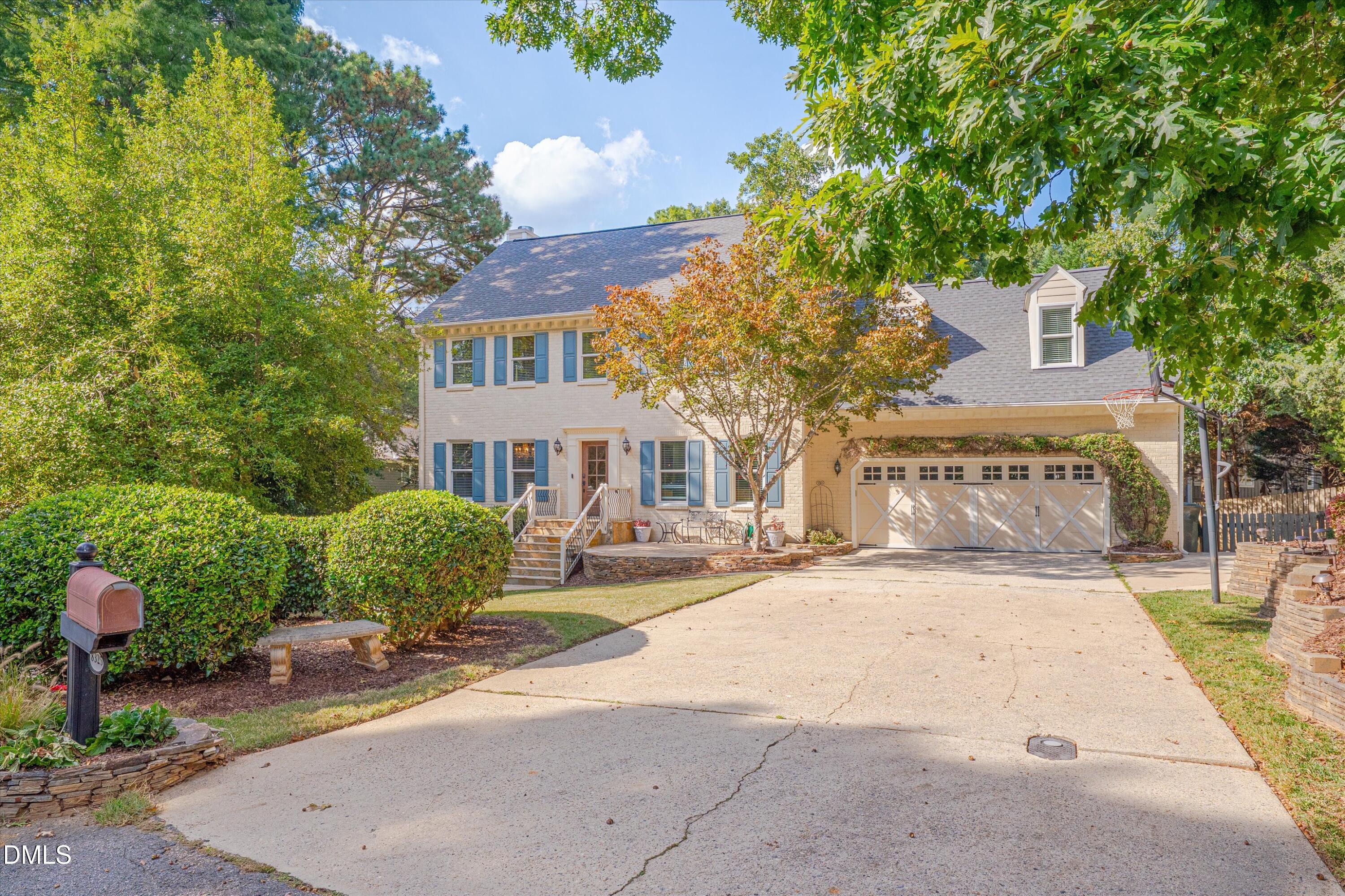 8325 Stryker Court Raleigh, NC 27615 - Photo 2 of 53 a front view of a house with a garden