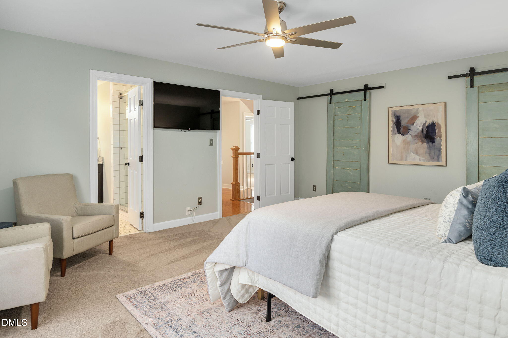 8325 Stryker Court Raleigh, NC 27615 - Photo 24 of 53 a bedroom with a bed couches and a flat screen tv
