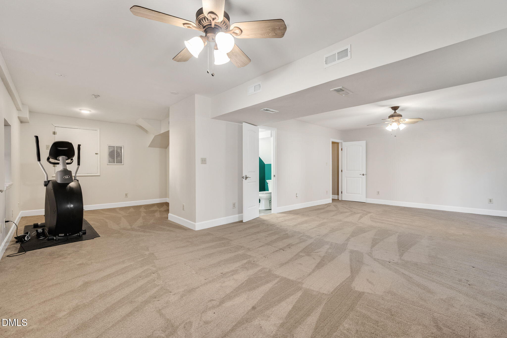 8325 Stryker Court Raleigh, NC 27615 - Photo 43 of 53 a view of a room with gym equipment and a chandelier fan