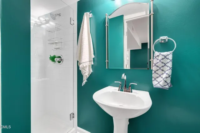 a view of a street with a building and trees in the background