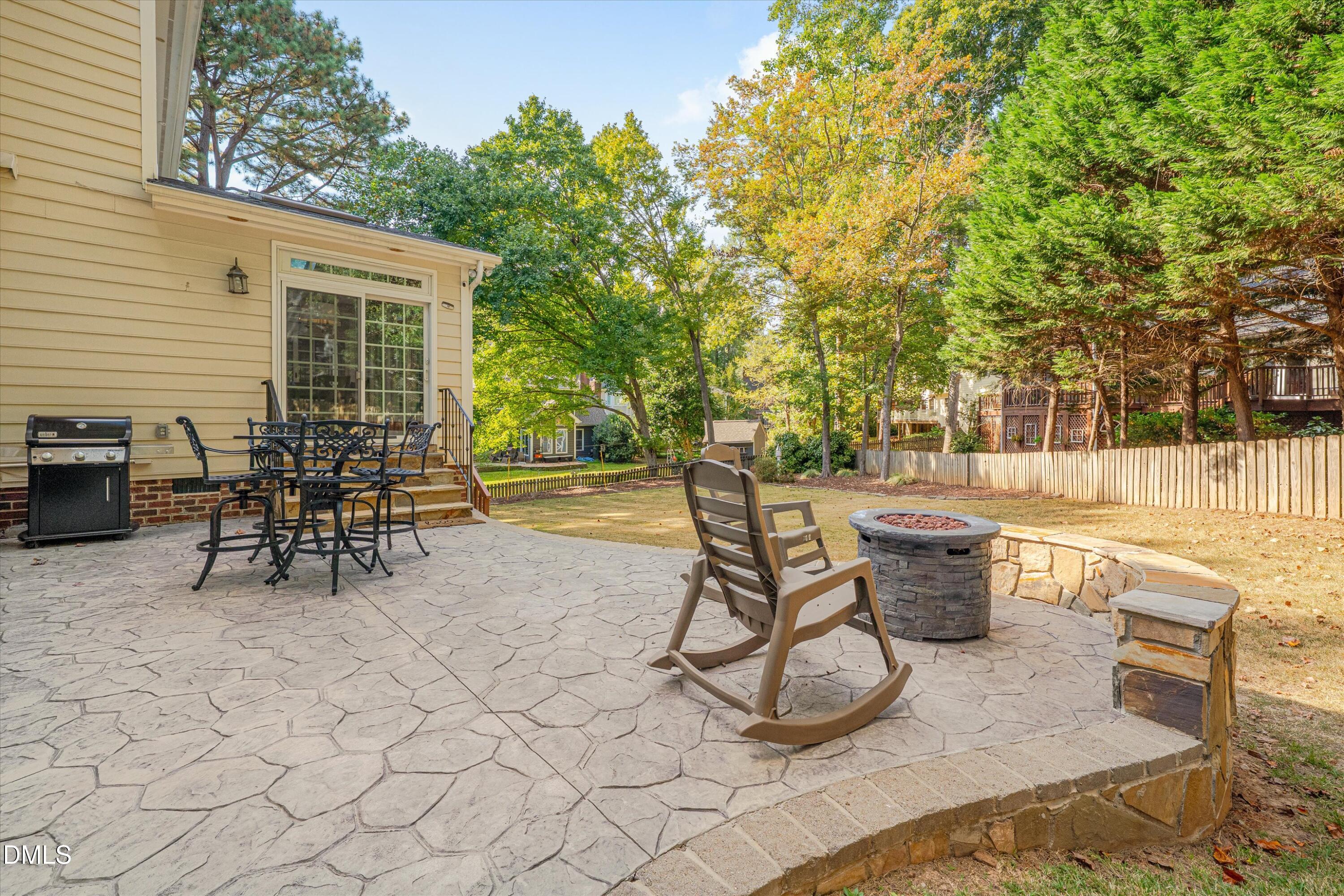 8325 Stryker Court Raleigh, NC 27615 - Photo 53 of 53 a view of a patio with table and chairs and potted plants