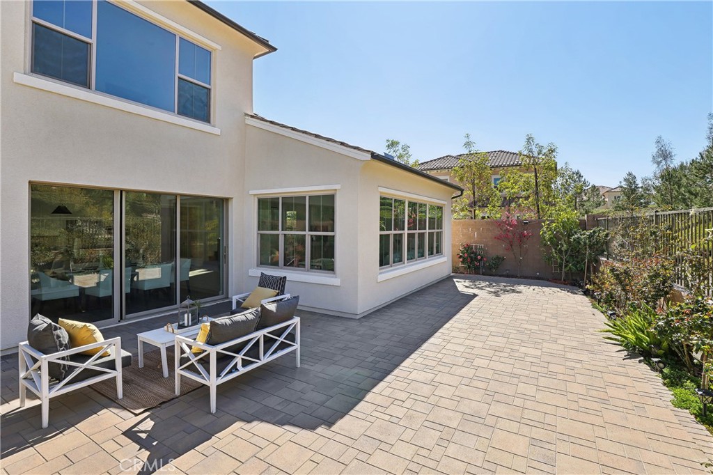 161 Sabbia Irvine, CA 92602 - Photo 9 of 11 a view of a patio with couple of chairs and potted plants on the wooden floor
