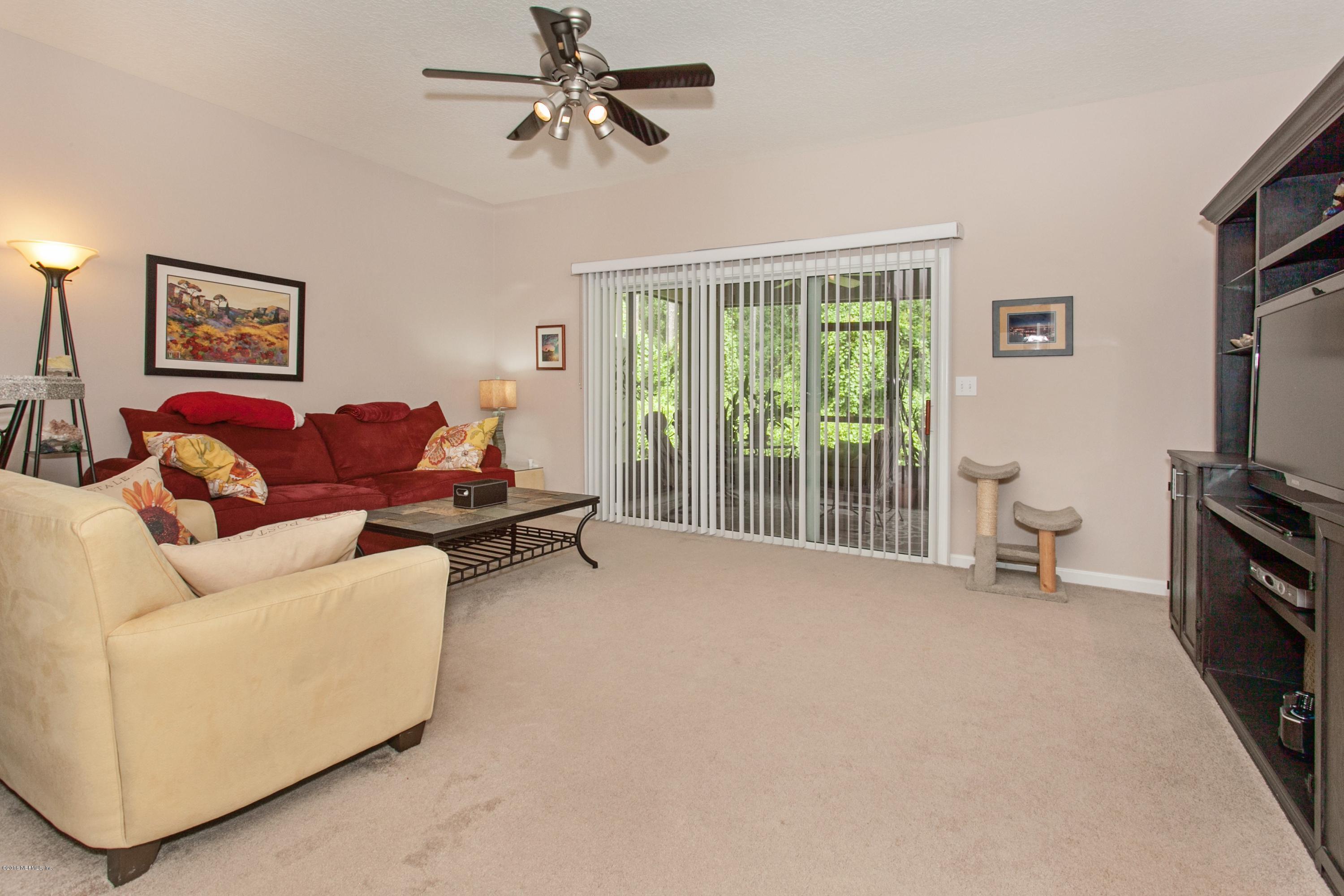 12911 Spring Rain Road Jacksonville, FL 32258 - Photo 3 of 14 a living room with furniture and a flat screen tv