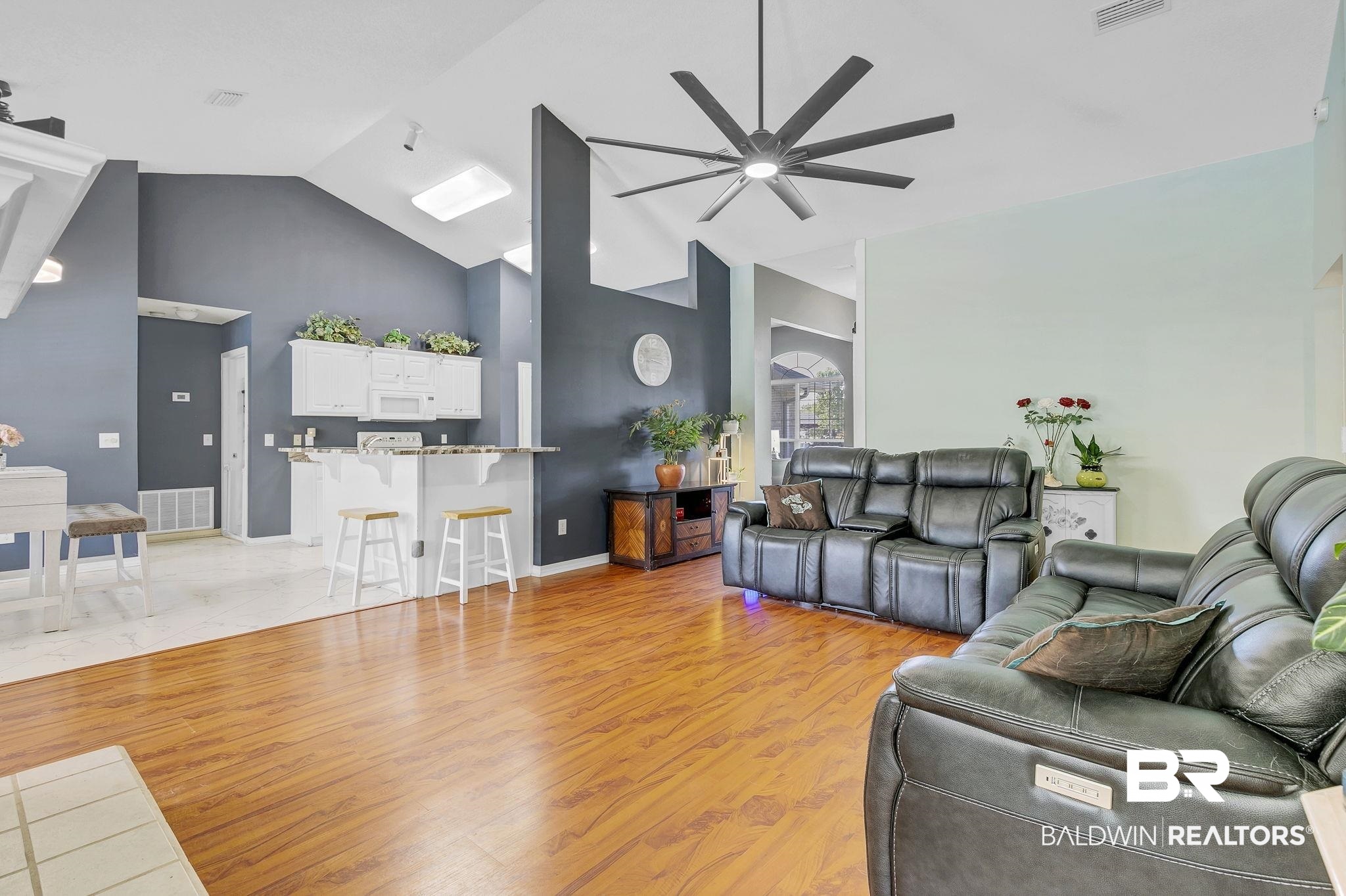 16358 Tempest Drive Foley, AL 36535 - Photo 9 of 46 Living area with visible vents, light wood-style floors, baseboards, high vaulted ceiling, and ceiling fan