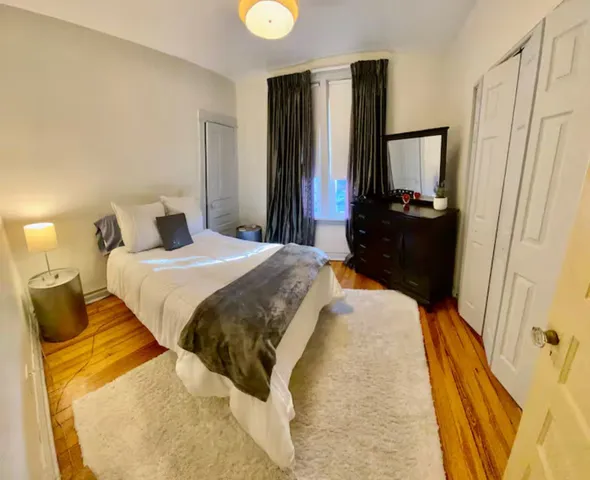 a bedroom with a bed and a mirror