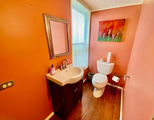 a bathroom with a toilet sink and mirror