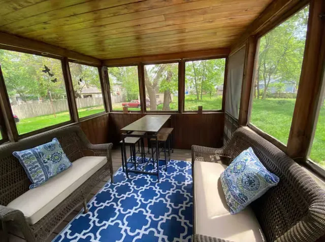 a living room with furniture and large windows
