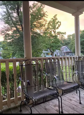 a view of a balcony with chair and table