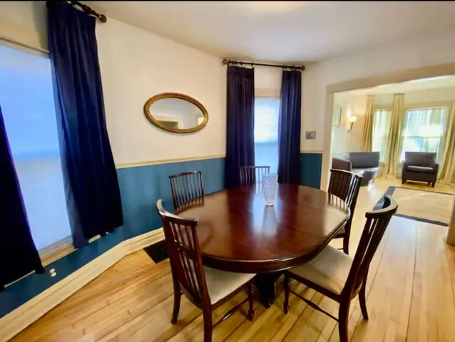 a view of a dining room with furniture and wooden floor
