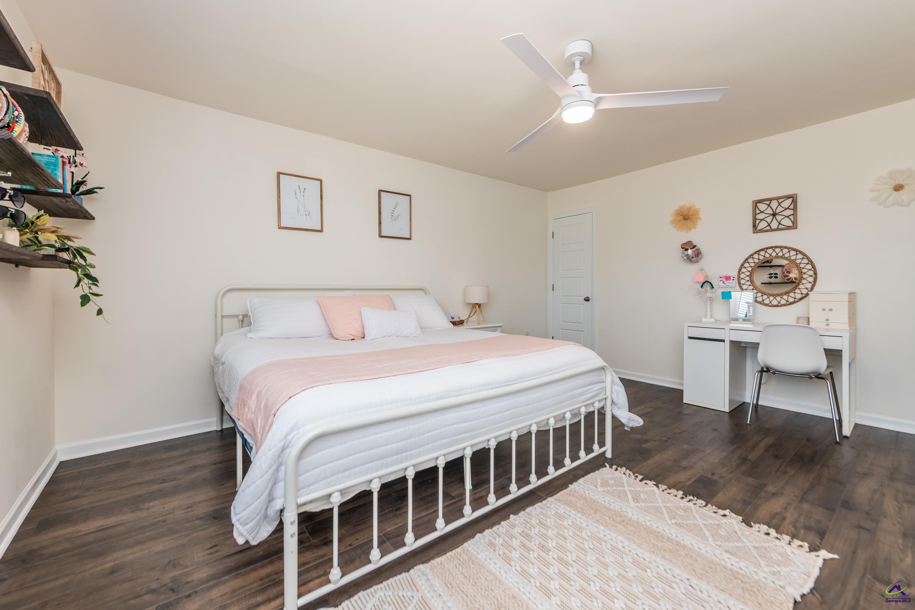 126 Farmers Way Perry, GA 31069 - Photo 31 of 39 a bedroom with a bed a table and a chandelier