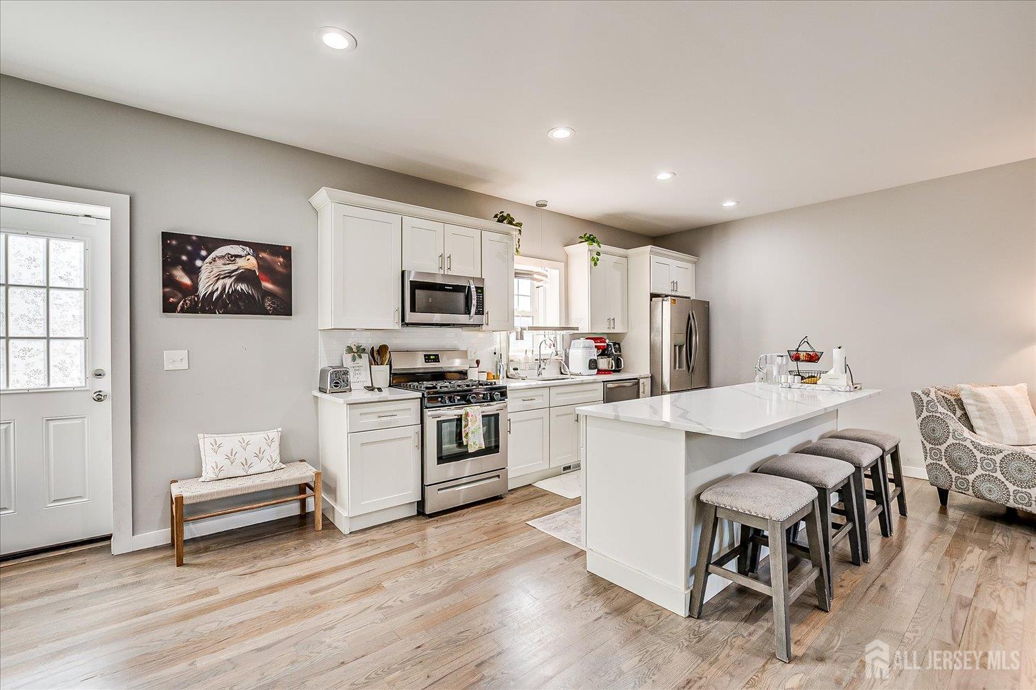 191 Hoover Avenue Edison, NJ 08837 - Photo 14 of 40 a kitchen with white cabinets and white appliances
