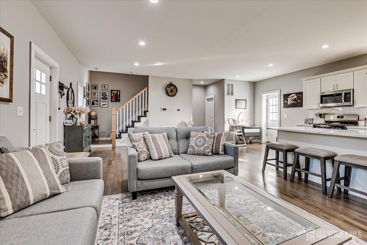 191 Hoover Avenue Edison, NJ 08837 - Photo 10 of 40 a living room with furniture a rug and kitchen view