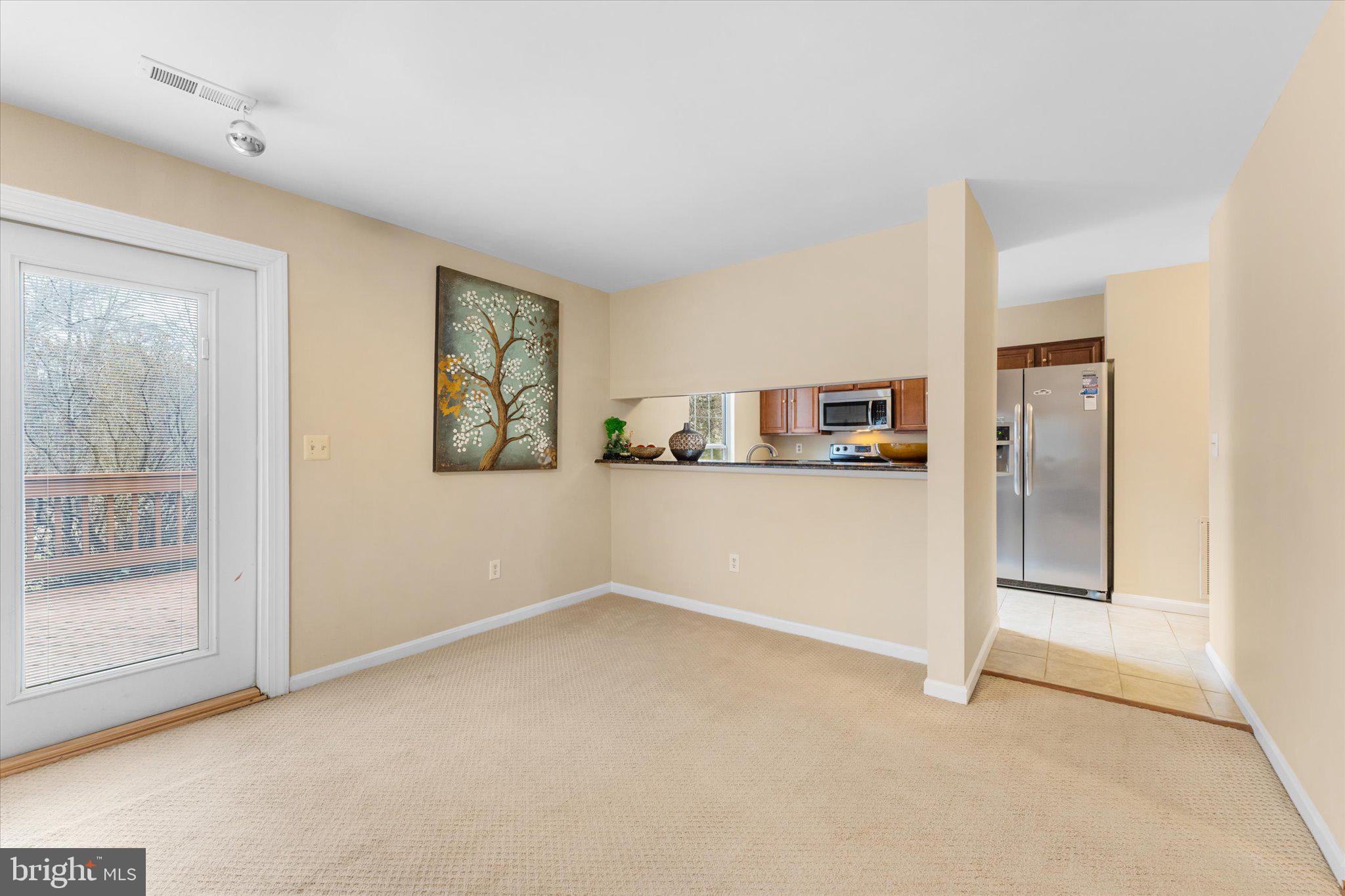 10140 Forest Hill Circle Manassas, VA 20110 - Photo 13 of 42 a view of a kitchen with refrigerator and window