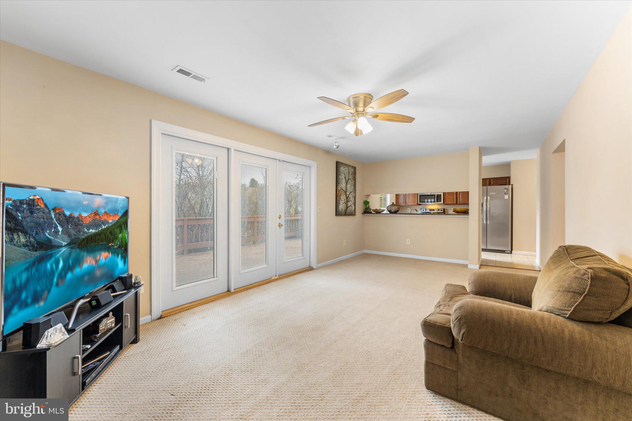 10140 Forest Hill Circle Manassas, VA 20110 - Photo 14 of 42 a living room with furniture and a flat screen tv
