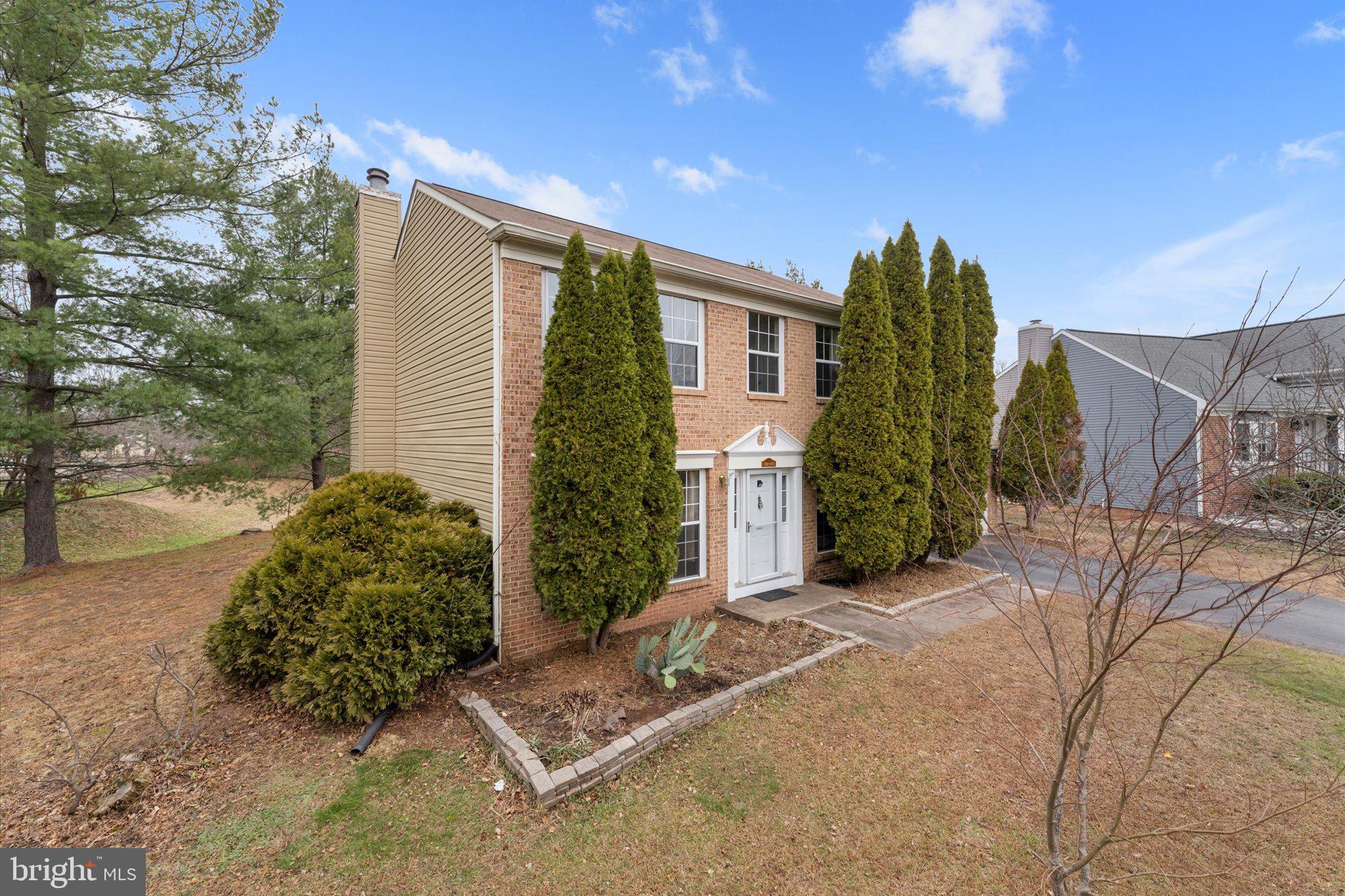 10140 Forest Hill Circle Manassas, VA 20110 - Photo 2 of 42 a view of backyard with potted plants and a large tree