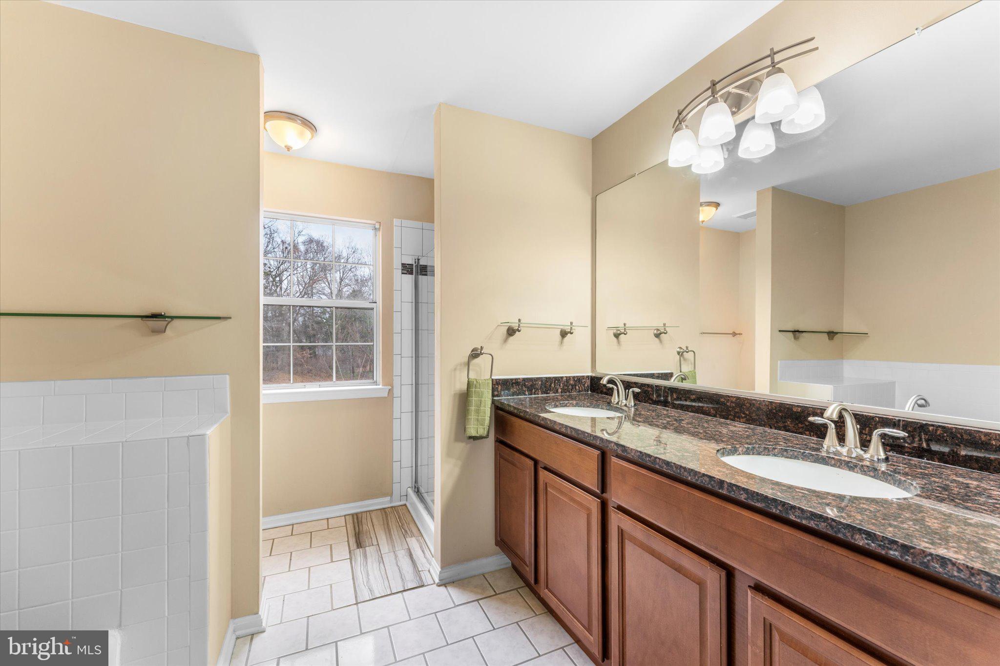 10140 Forest Hill Circle Manassas, VA 20110 - Photo 24 of 42 a bathroom with a granite countertop sink and a mirror