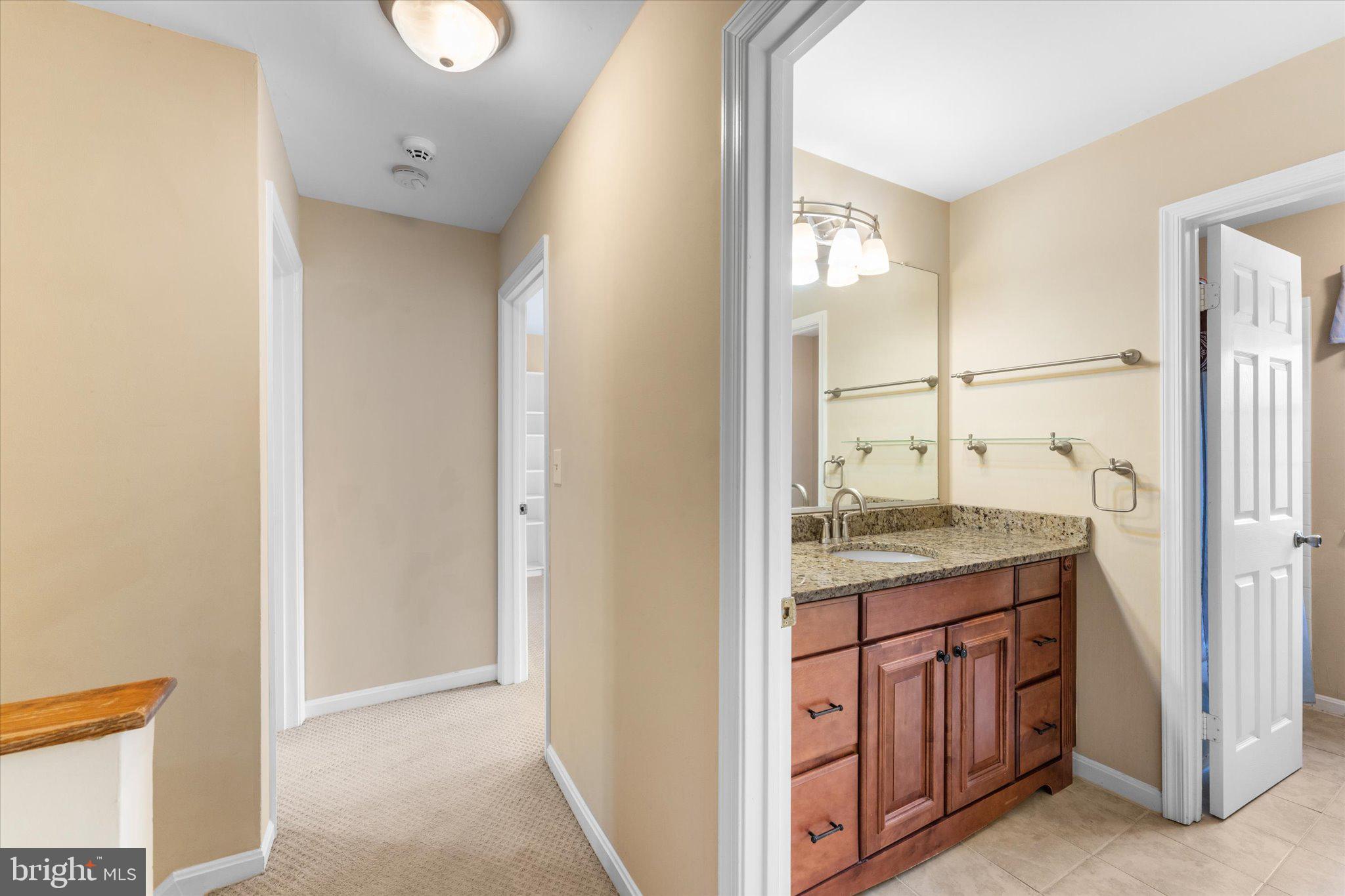 10140 Forest Hill Circle Manassas, VA 20110 - Photo 27 of 42 a bathroom with a granite countertop sink and a mirror