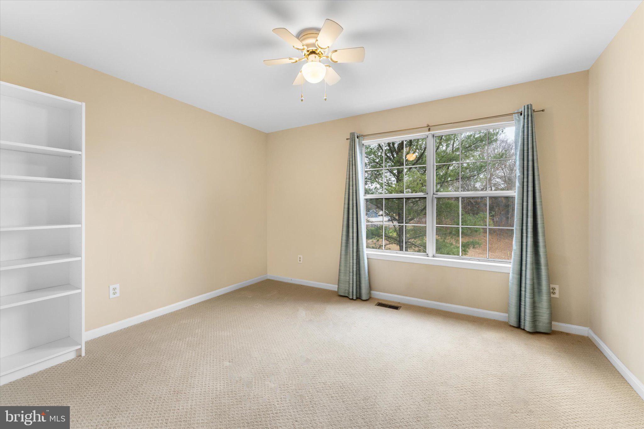 10140 Forest Hill Circle Manassas, VA 20110 - Photo 29 of 42 an empty room with a window and a fan