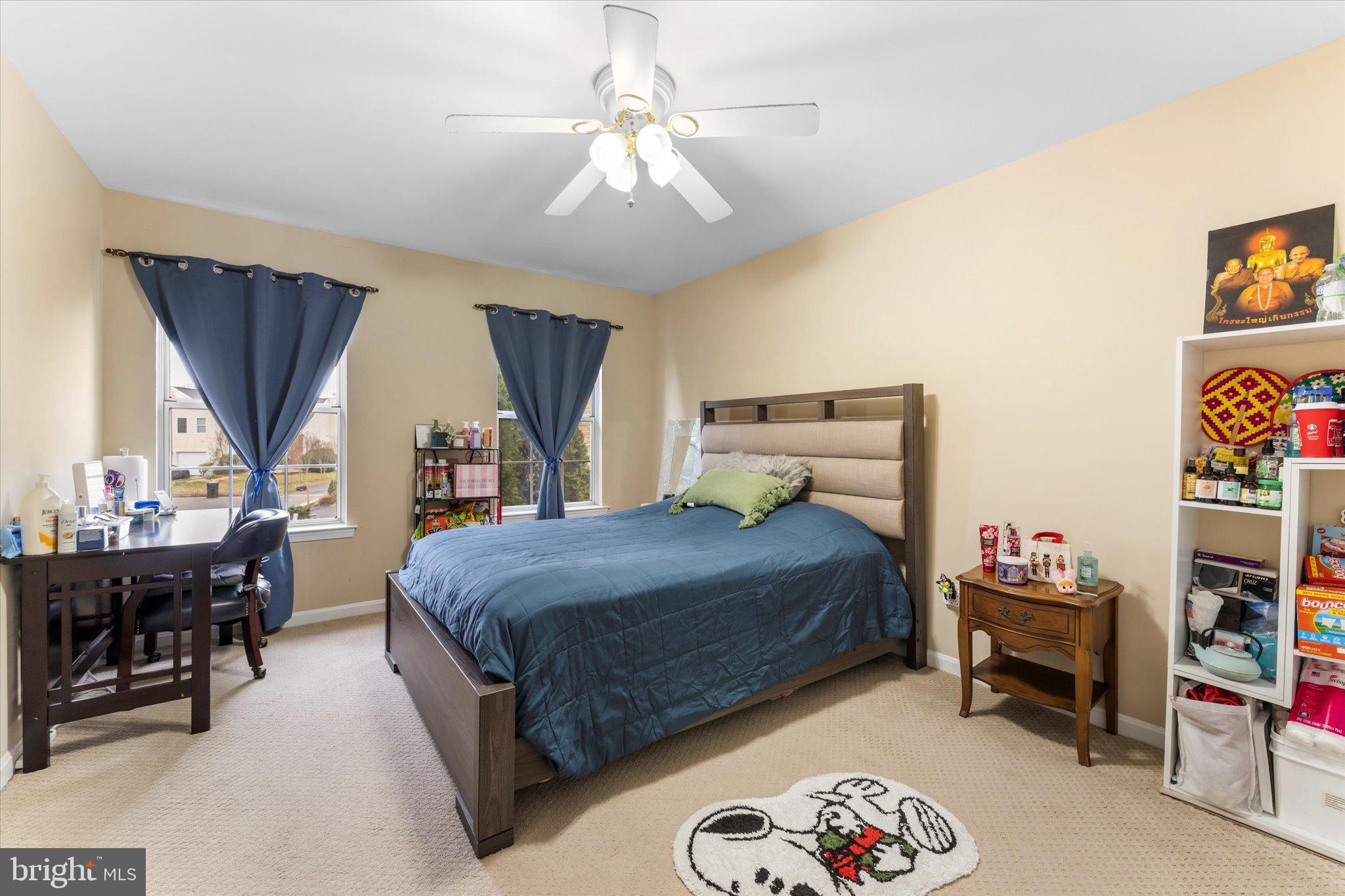 10140 Forest Hill Circle Manassas, VA 20110 - Photo 31 of 42 a bedroom with a bed and a chandelier