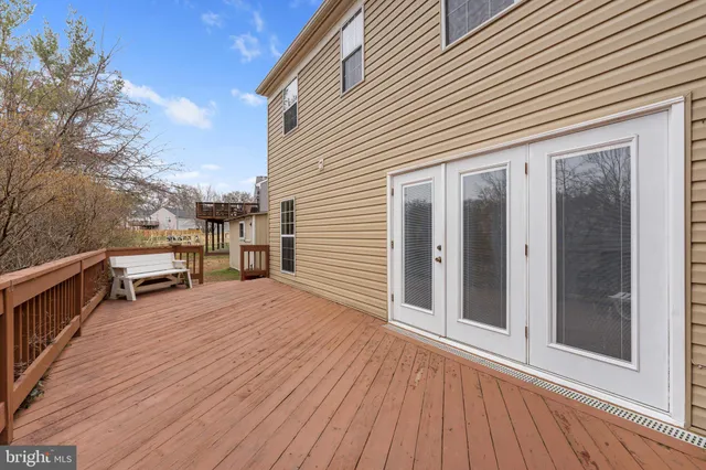 a view of a balcony with wooden floor and seating space
