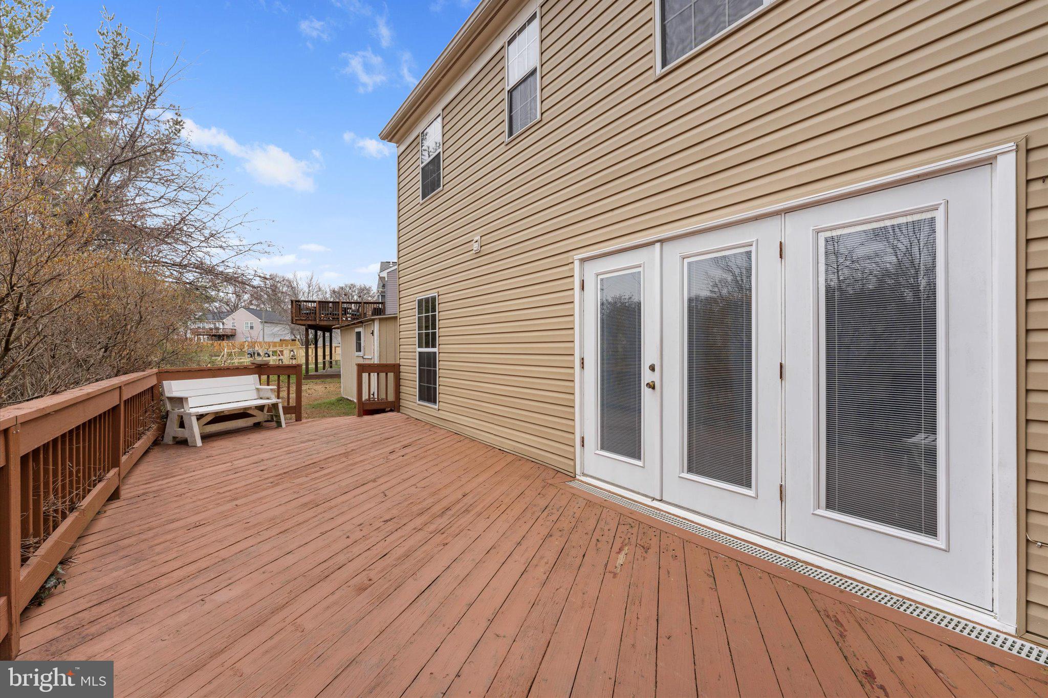 10140 Forest Hill Circle Manassas, VA 20110 - Photo 33 of 42 a view of a balcony with wooden floor and seating space
