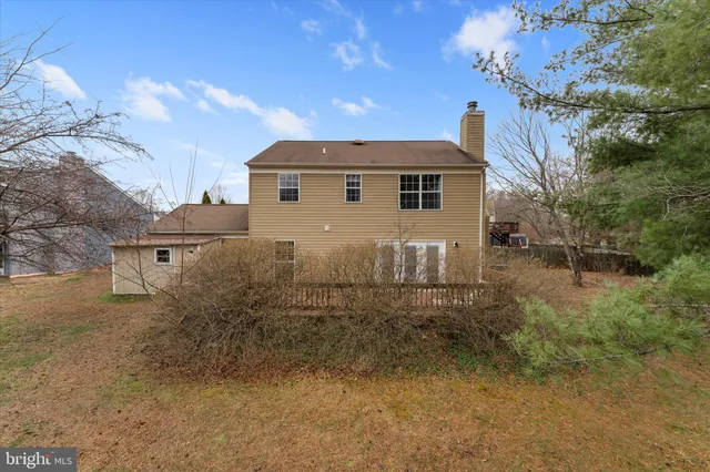 a front view of a house with yard and trees