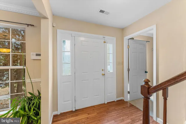 a view of a bedroom with wooden floor and entryway