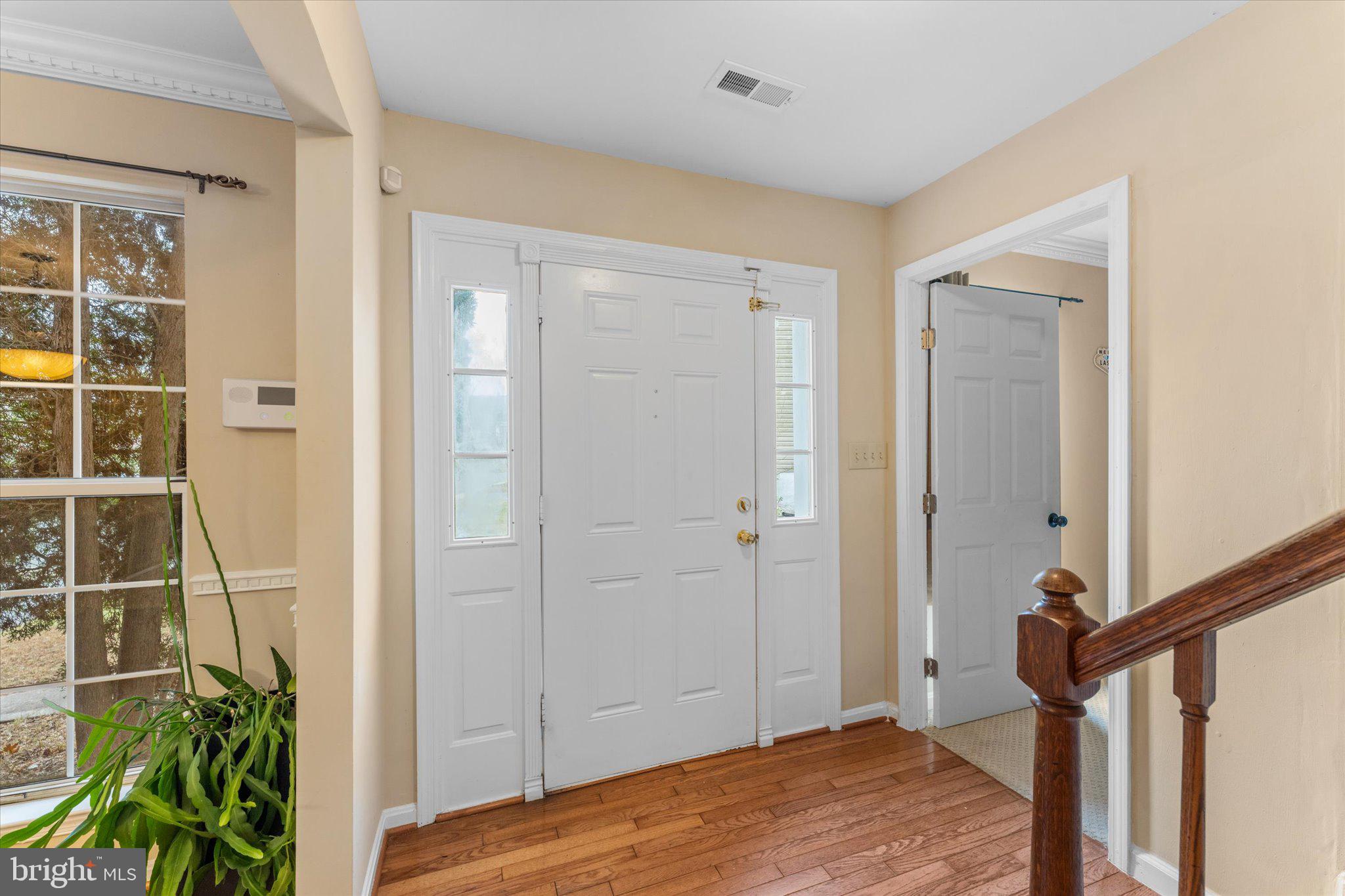10140 Forest Hill Circle Manassas, VA 20110 - Photo 4 of 42 a view of a bedroom with wooden floor and entryway