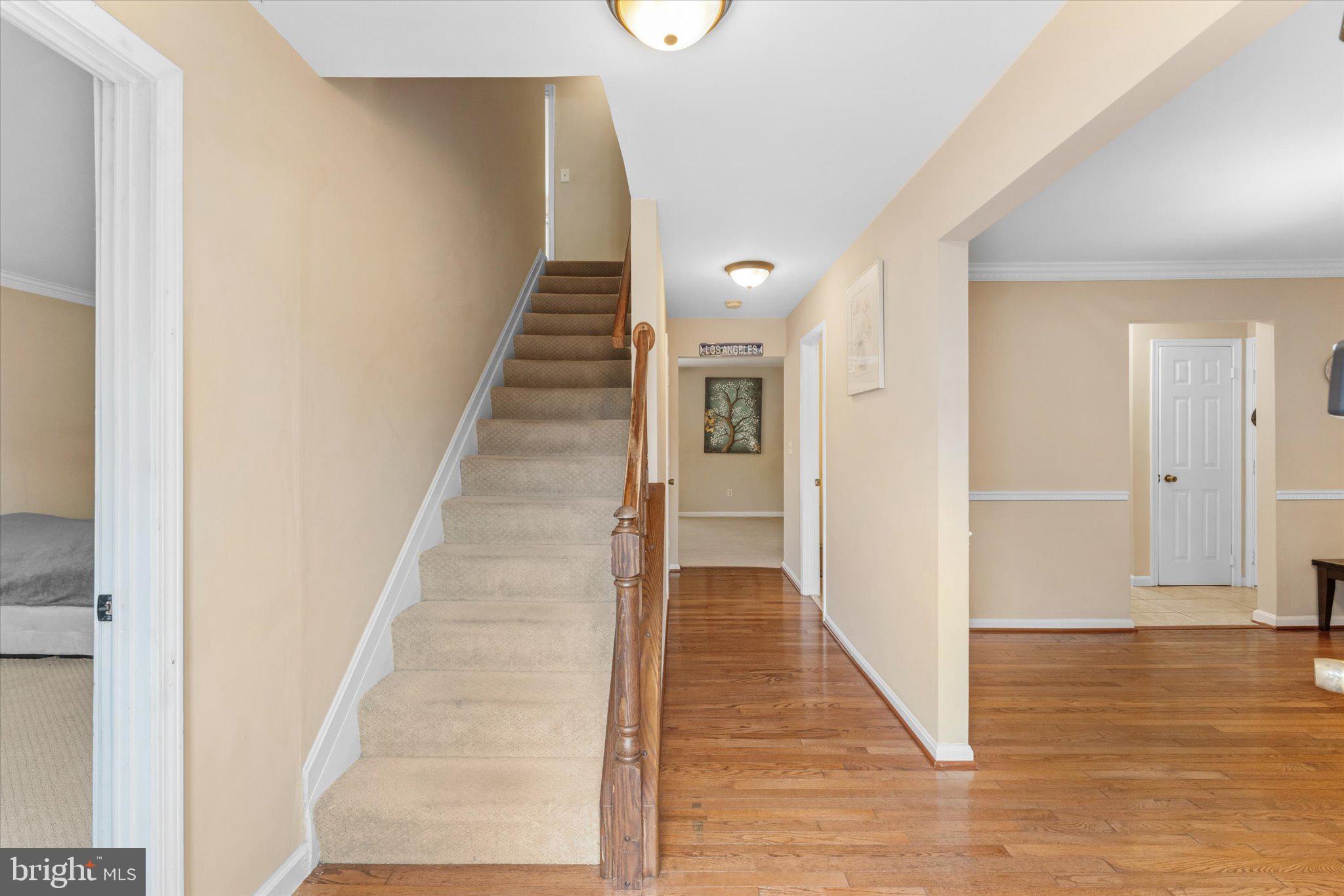 10140 Forest Hill Circle Manassas, VA 20110 - Photo 5 of 42 a view of a hallway with wooden floor and entryway