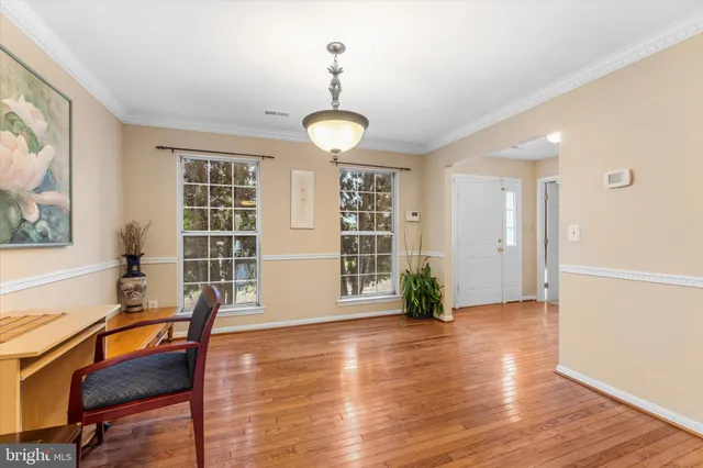 a view of a livingroom with furniture wooden floor and windows