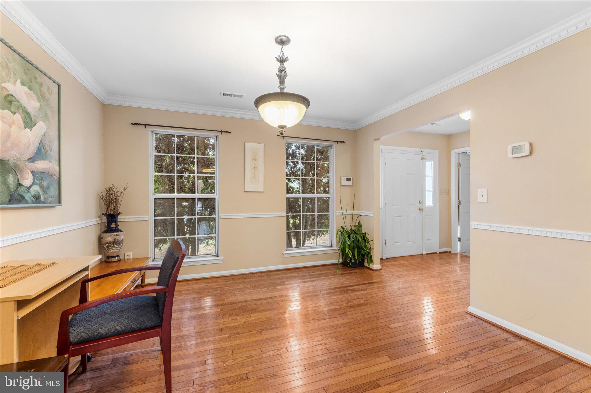 10140 Forest Hill Circle Manassas, VA 20110 - Photo 6 of 42 a view of a livingroom with furniture wooden floor and windows