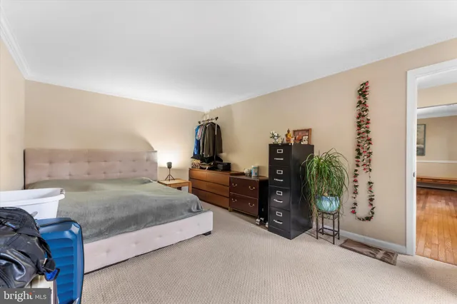 a bedroom with a bed and a couch