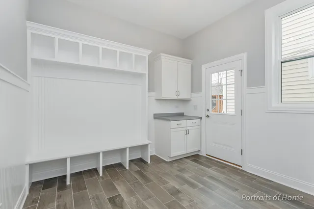 a view of kitchen with white cabinets and sink