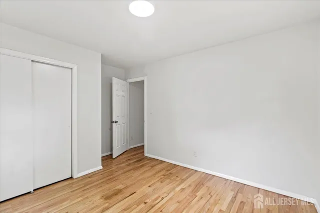 a view of an empty room and wooden floor