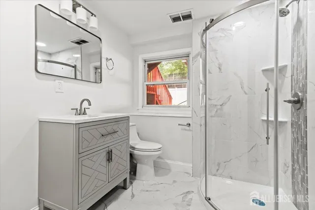 a bathroom with a sink toilet and shower