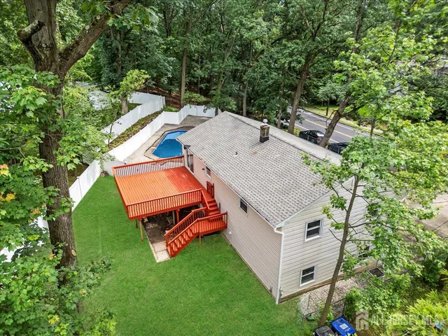 an aerial view of a house with backyard space and balcony