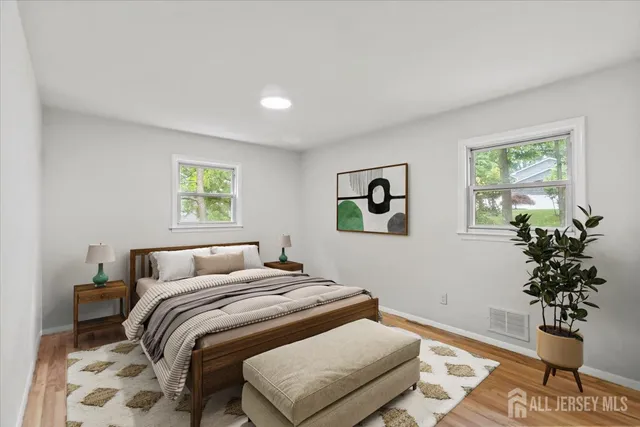 a bedroom with a bed and a potted plant