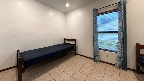 a bedroom with a bed and a window