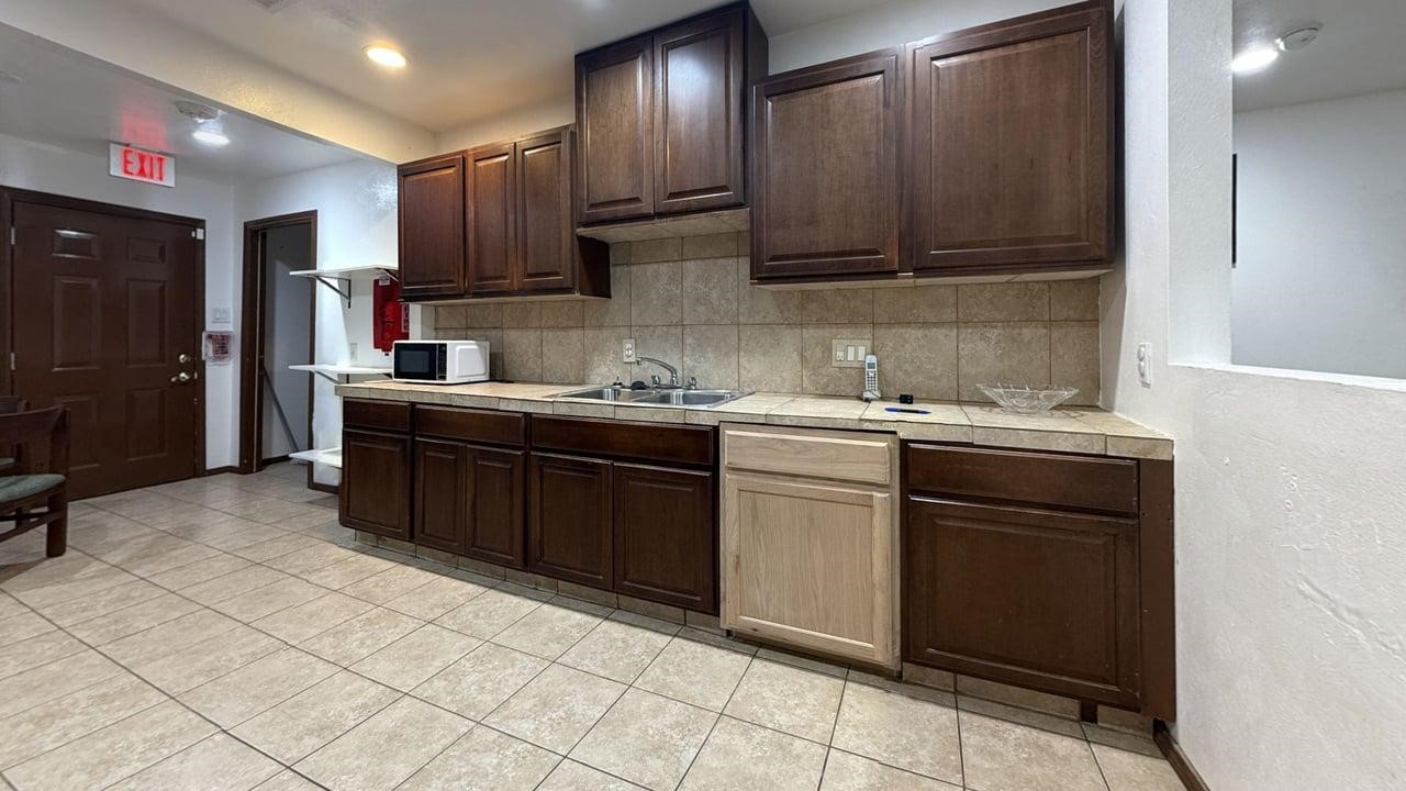 7975 Booker Street Houston, TX 77028 - Photo 23 of 36 a kitchen with stainless steel appliances granite countertop a sink stove and cabinets