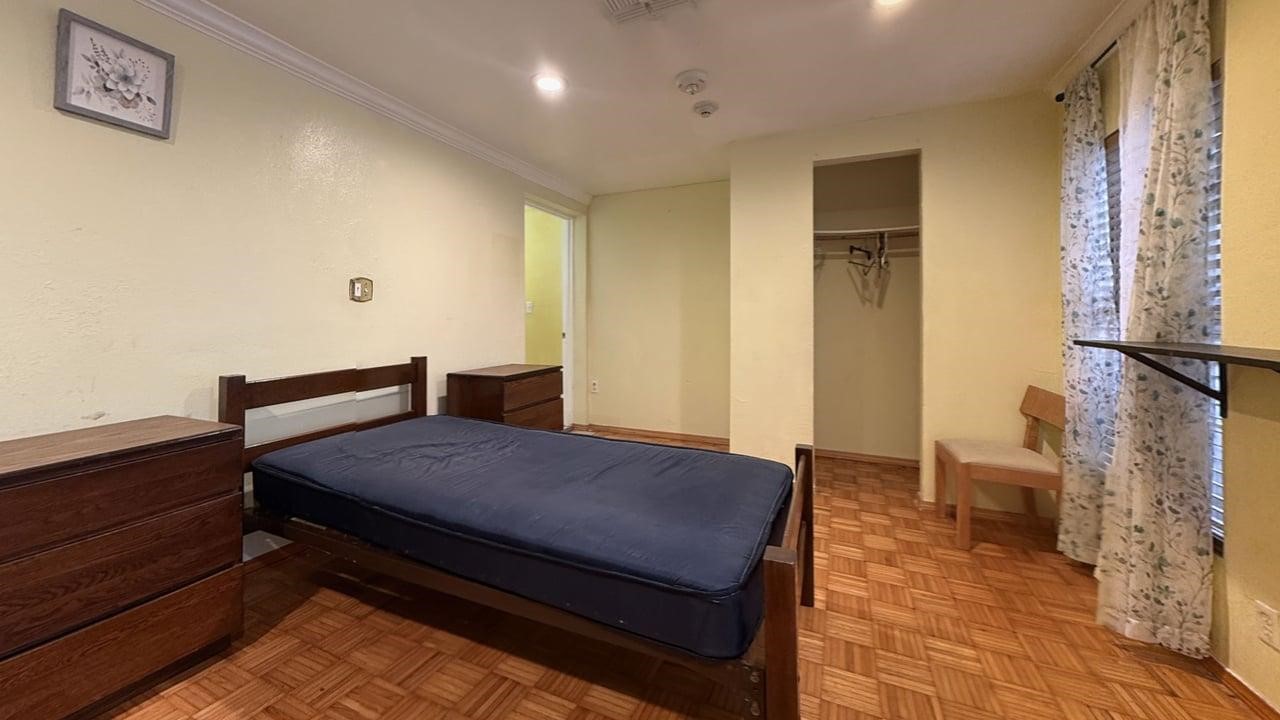 7975 Booker Street Houston, TX 77028 - Photo 6 of 36 a bedroom with a bed and wooden floor