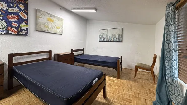 a view of a livingroom with furniture and a flat screen tv