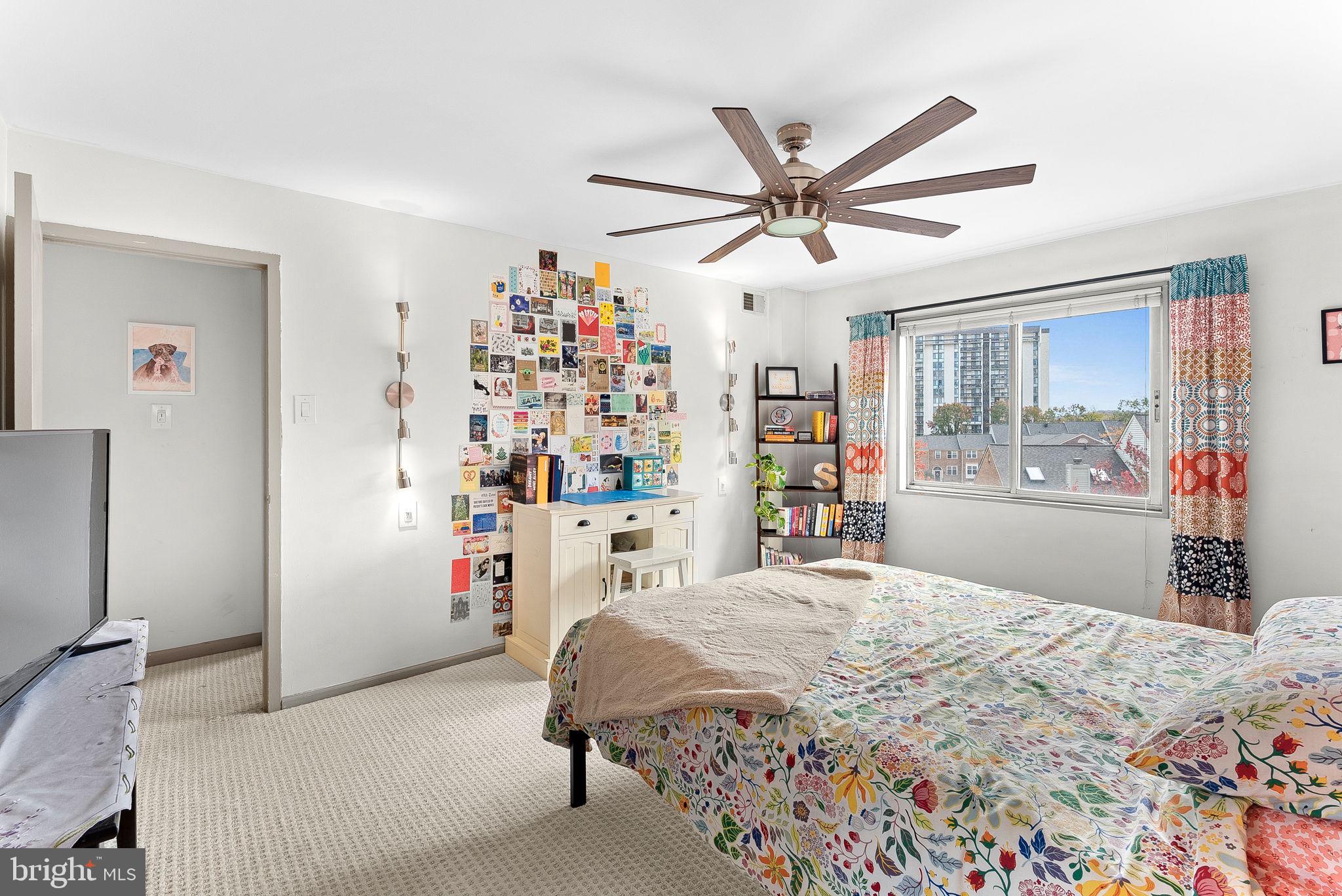 5340 Holmes Run Parkway, Unit 400 Alexandria, VA 22304 - Photo 17 of 40 a bedroom with a large bed and a chandelier
