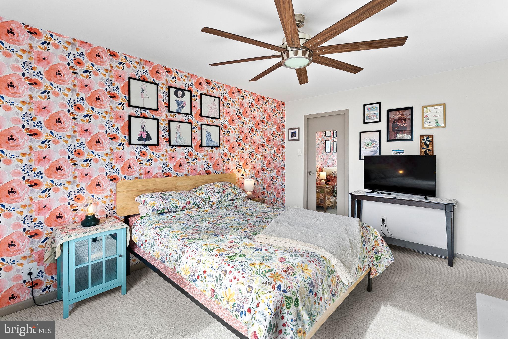 5340 Holmes Run Parkway, Unit 400 Alexandria, VA 22304 - Photo 18 of 40 a bedroom with a bed and a flat screen tv