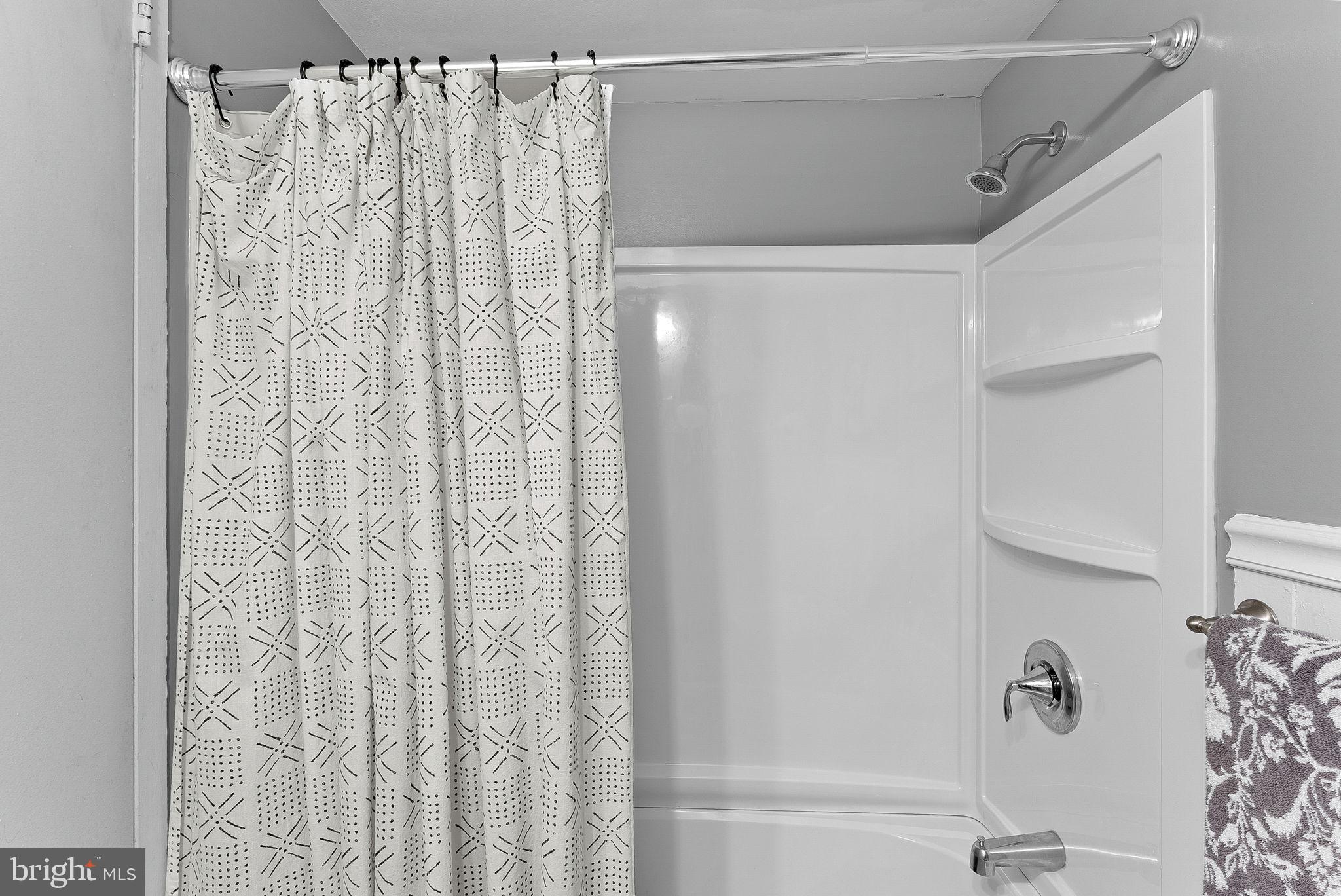 5340 Holmes Run Parkway, Unit 400 Alexandria, VA 22304 - Photo 23 of 40 a bathroom with a shower curtain and a shower curtain