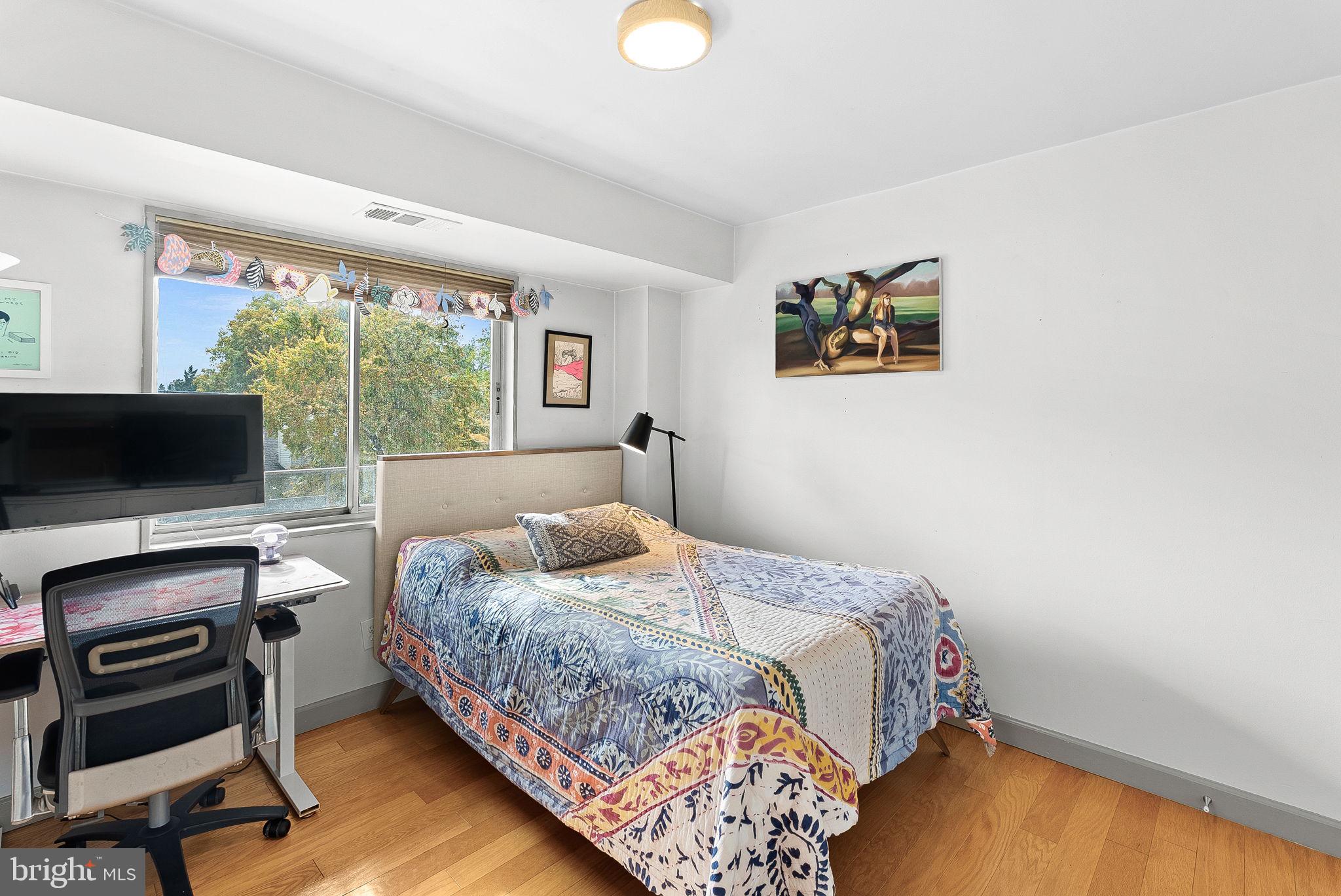 5340 Holmes Run Parkway, Unit 400 Alexandria, VA 22304 - Photo 25 of 40 a bedroom with a bed and flat screen tv