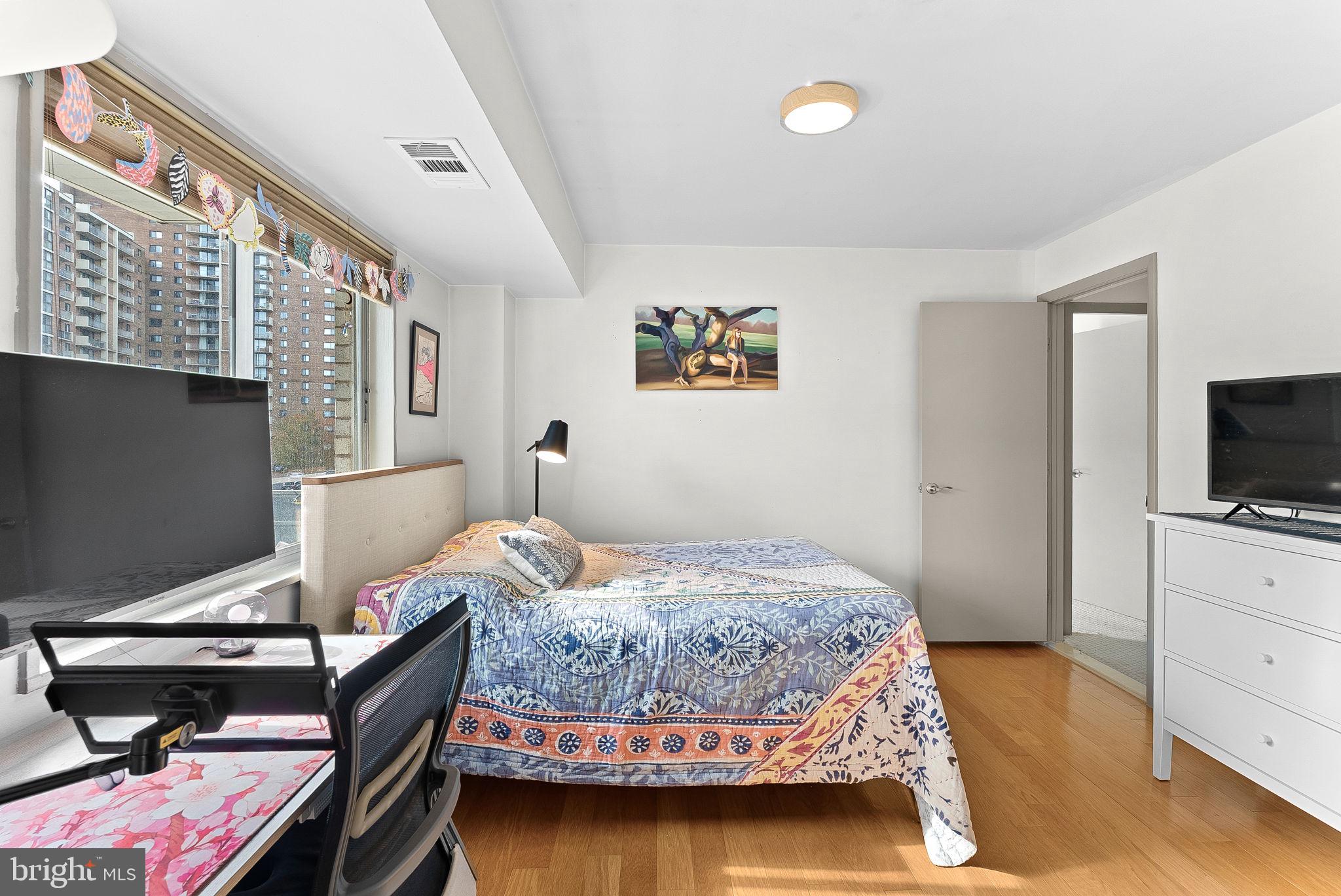 5340 Holmes Run Parkway, Unit 400 Alexandria, VA 22304 - Photo 26 of 40 a bedroom with a bed and a flat screen tv