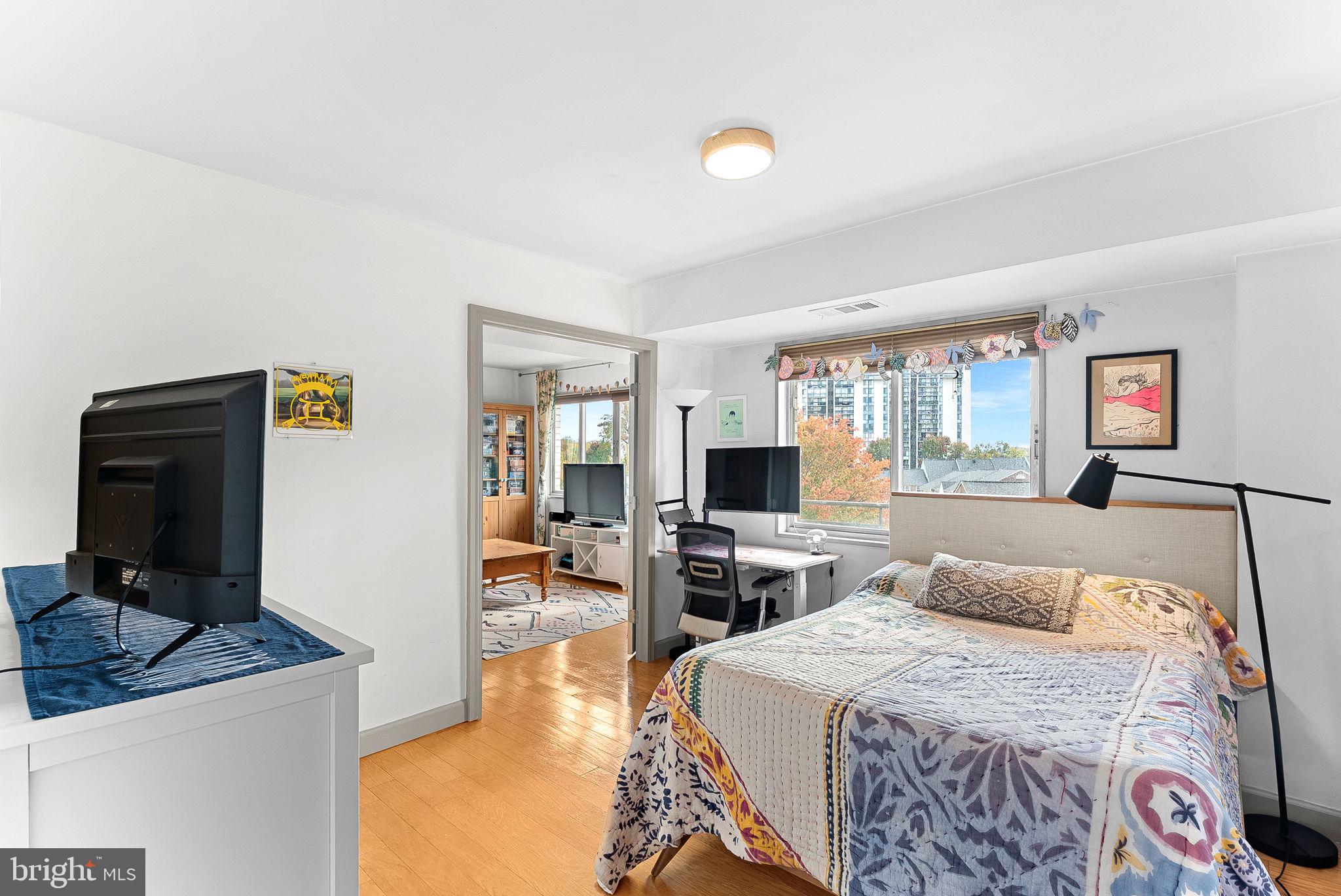 5340 Holmes Run Parkway, Unit 400 Alexandria, VA 22304 - Photo 27 of 40 a bedroom with a bed and wooden floor