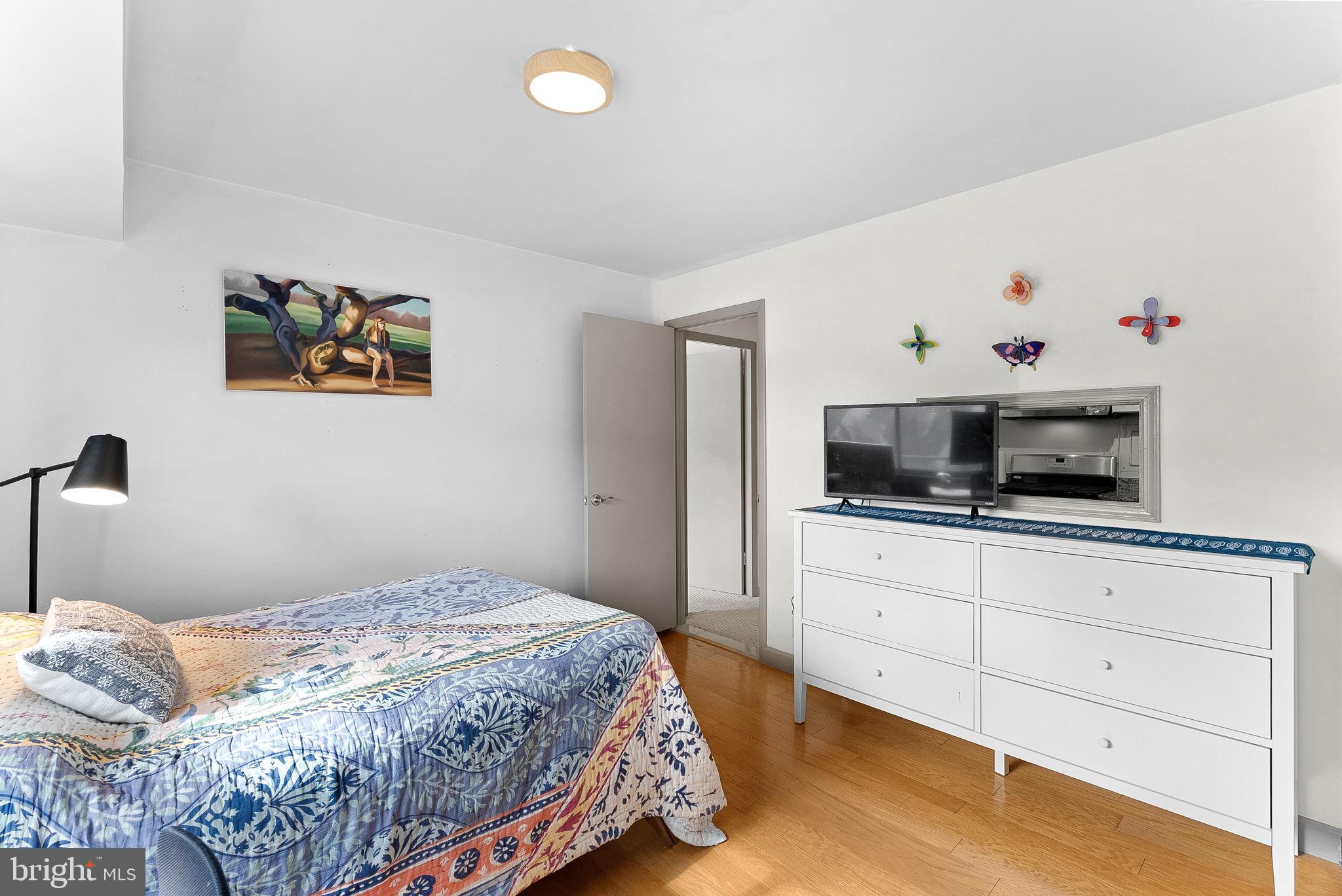 5340 Holmes Run Parkway, Unit 400 Alexandria, VA 22304 - Photo 28 of 40 a bedroom with a bed and flat screen tv